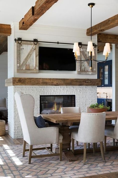 Modern Farmhouse Dining Room with Rustic Wood Beams, Mantel and Sliding Barn Doors to Cover the TV Rustic Wood Beams, Kitchen Dining Room Combo, Farmhouse Style Dining Room, Cottage Dining Rooms, Wood Mantel, Modern Farmhouse Dining Room, Dining Room Fireplace, Dining Room Paint, Double Sided Fireplace