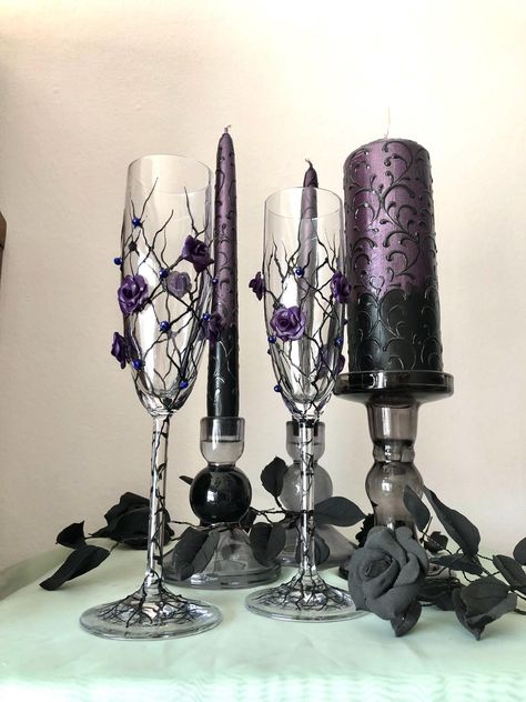 Hand painted black champagne flutes with dark purple roses and hand painted Unity candle set Black Silver And Lilac Wedding, Dark And Light Purple Wedding, Black And Purple Wedding Reception, Lavender And Black Wedding Decorations, Black And Purple Table Setting, Purple And Black Quince, Black And Purple Wedding Ideas, Purple And Black Wedding Ideas, Midnight Purple Wedding