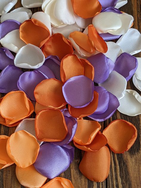 "Sneeze-Free Flowers - Allergy-Friendly Artificial Petals for Brides Who Want to Shine, Not Hide Behind a Red Nose on Their Big Day!" Burnt orange and lilac rose petals for wedding and birthday party decor-custom simple table centerpieces-bridal shower floral confetti 🌸Reusable🌸 💰 Apply coupon code " SAVEMORE" to receive 20% OFF when you buy 200 petals or more 💰  Inexpensive, affordable, fresh looking appearance, low maintenance, easy to clean, hassle and allergen-free, and 100% venue friend Lilac And Burnt Orange Wedding, Orange And Purple Decor, Orange Lilac Color Palette, Burnt Orange Colour Combinations, Orange And Purple Bridesmaid Dresses, Lavender And Burnt Orange Wedding, Light Purple And Orange Wedding, Purple And Orange Wedding Ideas, Purple Wedding Theme Color Combinations