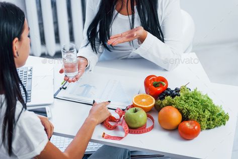 Female nutritionist gives consultation to patient indoors in the office by mstandret. Female nutritionist gives consultation to patient indoors in the office. #Sponsored #consultation, #nutritionist, #Female, #patient Omnivore Diet, High Protein Fruit, Social Media Photography, Media Photography, Logo Graphic Design, Brochure Layout, Daily Vitamins, Green Vegetables, Nutrition Coach