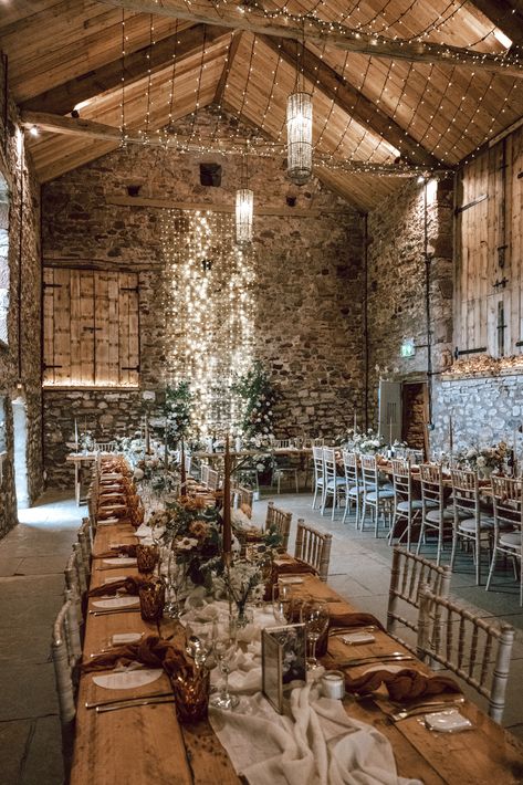 Eden Barn wedding venue with fairy lights and rustic wedding decor with flower columns for autumnal weddng styling | wedding venues in the UK | barn wedding venues in UK | wedding lighting | wedding table decor | Lucy Alexandra Photography Brown Wedding Venue Ideas, Rustic Princess Wedding, Simple Wedding Venue Ideas Receptions, Cosy Wedding Decor, Wedding Ranch, Indoor Rustic Wedding, Uk Farm Wedding, Barndominium Wedding, Autumn Wedding Uk