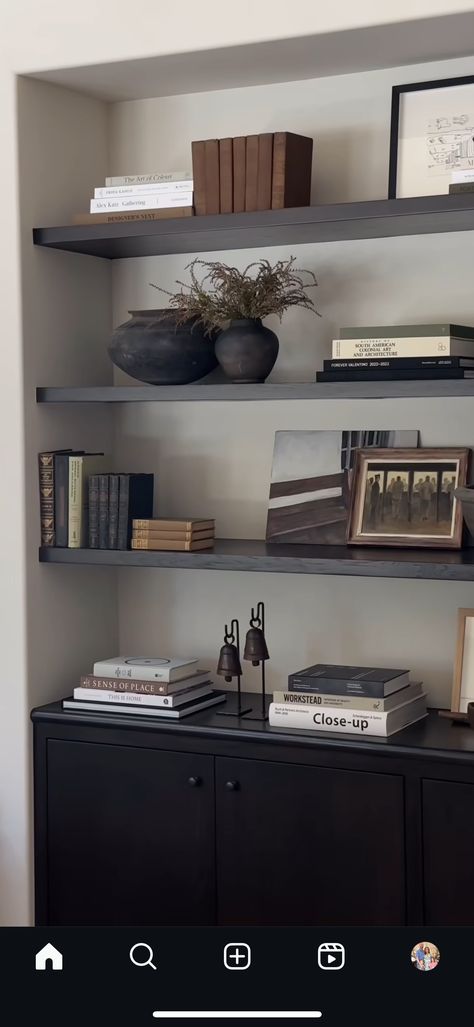 Styling Black Shelves Living Rooms, Manly Bookshelf Decor, Mens Office Bookshelf Decor, Transitional Bookshelf Styling, Masculine Bookshelf Decor, Black Bookcase Styling, How To Style Bookshelves Built Ins, Dark Wood Floating Shelves, Minimalist Bookshelf Decor