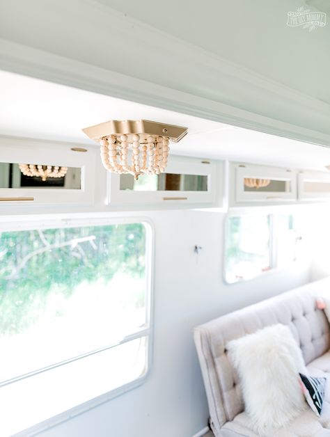 See how I transformed a flush mount fixture in our camper with this ceiling light DIY $7 boho makeover! Diy Camper Light Cover, The Diy Mommy, Rv Light Cover Ideas, Camper Light Fixtures, Diy Rv Light Covers, Rv Light Fixture Makeover, Ceiling Light Makeover, Light Covers Diy, Diy Wood Bead Chandelier