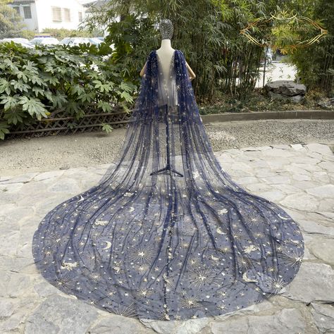 Step into a fairytale with our "Enchanted Nights" navy blue cathedral length veil, featuring dazzling silver sequin embellishments of stars, moon, and winged horses. This exquisite veil is perfect for brides who want to add a touch of magic to their wedding day look. The intricate sequin work on the veil creates a stunning sparkle effect that will make you shine like a star. The cathedral length veil adds a touch of elegance and sophistication to your wedding dress, making you feel like a true p Silver Wedding Veil, Royal Blue Wedding Veil, Blue Star Wedding Dress, Navy Blue And Gold Wedding Dress, Celestial Wedding Dress Blue, Navy Blue Wedding Dress The Bride, Moon Themed Wedding Dress, Moon And Stars Wedding Dress, Night Sky Wedding Dress