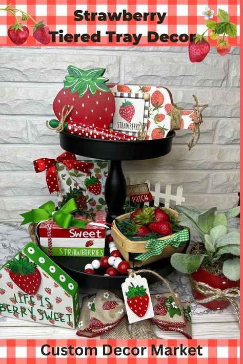 Two tiered back trays decorated with various strawberry themed handmade decor pieces. Includes a small book stack that says Sweet Strawberries, a rolling pin that says Berrylicious, a small basket with fake strawberries with a green bow, a cut-out and hand painted strawberry shape and other strawberry themed items. Strawberry Kitchen Decor Ideas, Strawberry Tiered Tray Decor, Decorating With Strawberries, Diy Tray Decor, Strawberry Crafts, Summer Tiered Tray Decor, Strawberry Stuff, Strawberry Decor, Summer Tiered Tray