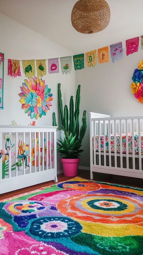 Bright Mexican fiesta-themed nursery with cacti, paper flags, a pink houseplant, rainbow rug, and a white crib. Mexican Themed Nursery, Mexican Nursery Decor, Gender Neutral Nursery Design, Wooden Crib, Colorful Nursery, Wooden Cribs, Nursery Designs, Rainbow Rug, Fiesta Theme