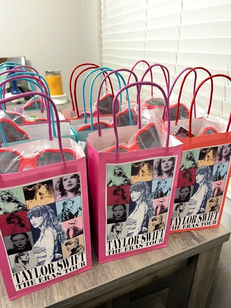 DIY Taylor Swift Eras Tour Party Bags. Printed logo, treats, heart shaped glasses from Amazon, Stickers from Amazon Eras Tour Gift Bags, Eras Tour Goodie Bag, Taylor Swift Swag Bag Ideas, Swiftie Party Decor, Taylor Swift Eras Birthday Theme, Taylor Swift Birthday Party Ideas Evermore, Taylor Swift Birthday Theme Ideas, Taylor Swift Candy Table, Lover Taylor Swift Birthday Theme