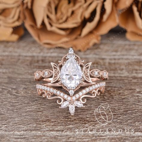 Unique Pear Shaped Moissanite Engagement Ring Set 2PCS Rose Gold Marquise Wedding Band Women Moon Ring Vine Flower Ring Bridal Set Milgrain * Ring Material: solid 14k rose gold, yellow gold and white gold  * Center Stone: Colorless Moissanite, in Pear  * Center Stone Size: 6x8mm / 1.2ct  * Side Stone: Natural Diamond or Moissanite, about 0.2ct * Bandwidth: 1.5mm * Buy them separately:  Engagement ring: https://www.etsy.com/listing/1588933506 2-3 WEEKS PROCESSING TIME MADE IN US * Shipping * FREE Moissanite Bridal Ring Sets, Vintage Black Wedding Ring, Nested Wedding Band, Vintage Pear Ring, Unique Wedding Rings Engagement Bridal Sets, Pear Shape Rings, Engagement Rings Teardrop, Wedding Rings Engagement Gold, Gold Marquise Wedding Band