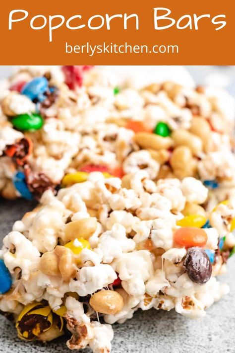 Popcorn bars are a gooey, sweet snack that's loaded with melted marshmallows, chocolate candies, and savory peanuts. #berlyskitchen Popcorn Bar Recipes, Chocolate Candies, Popcorn Bar, Recipes With Marshmallows, Marshmallow Creme, Popcorn Recipes, Rice Crispy Treats, Trending Recipes, Crispy Treats