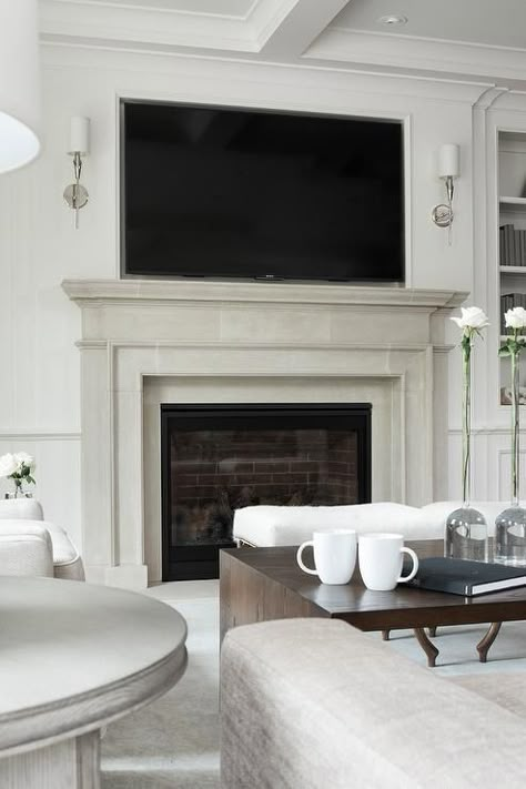 This limestone mantel says “I’m modern and clean looking and I’m cooking with gas”! (pun intended..again) Transitional Fireplace Ideas With Tv, Fireplace With Tv Over It, Sconces Flanking Tv, Sconces By Tv, Tv Over Mantel, Fireplace Sconces Lighting, Sconces Next To Tv, Fireplaces With Tv Above, Fireplace With Tv Above