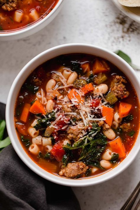 It's time to kiss boring & bland minestrone goodbye for good! My Best-Ever Hearty Minestrone Soup is absolutely packed with rich flavor thanks to a secret ingredients: Italian sausage, beans, kale, & loads of flavorful aromatics make this hearty minestrone soup seriously bold, extra cozy, & super satisfying. The perfect winter soup! Make ahead-friendly, freezer-friendly. #minestronesoup #souprecipes #soupideas #soupsandstews #comfortfood #comfortfooddinners #soup #italianrecipes #italiansoup Hearty Minestrone Soup Recipe, Gf Soup, Sausage Beans, Minestrone Soup Recipe, Winter Soup, Italian Soup, Minestrone Soup, Fall Soups, Cozy Meals