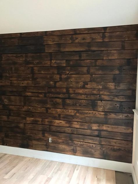 Also known as shou sugi ban, we charred oak for this accent wall. Pallet Wall Decor Living Room, Burnt Shiplap Wall, Shou Sugi Ban Accent Wall, Burnt Wood Accent Wall, Burnt Wood Trim, Basement Accent Wall Ideas, Stained Wood Walls, Charred Wood Wall, Burned Wood Wall