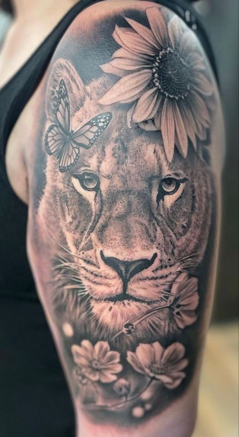 230+ Lioness Tattoo Ideas and Designs (2023) - TattoosBoyGirl Upper Arm Tattoo Designs For Women, Lioness And Sunflower Tattoo, Lion And Lioness Tattoo For Women, Black And Grey Lion Tattoo, Lioness Tattoo For Women Half Sleeves, Lion Sleeve Tattoo Woman, Female Lion Tattoo For Women, Shoulder And Upper Arm Tattoos For Women, Lioness Tattoo For Women