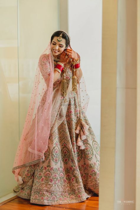 Photo of Bride fixing her earrings. Baby Pink Bridal Lehenga, Pastel Mehndi, Muslim Wedding Poses, Pink Wedding Outfit, Pastel Bridal Lehenga, Lehenga Looks, Indian Bride Dresses, Sari Look, Shaadi Ideas