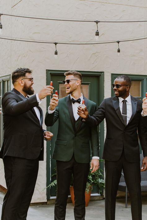 Winter Groom Attire Green, Black Suit With Forest Green Tie, Tan Suit With Emerald Green, Black Tux Emerald Green Tie, Forest Green Wedding Party Groomsmen, Dark Green Bridal Party Groomsmen, Deep Green Tuxedo, Green Suit Black Tie, Groom In Green Groomsmen In Black