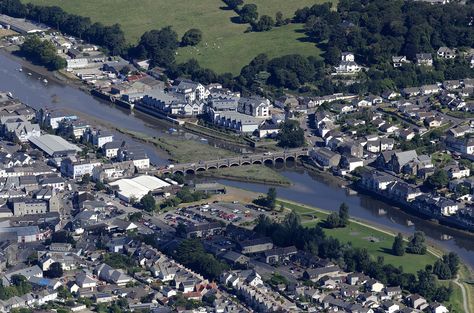 Wadebridge in Cornwall - aerial UK view by John Fielding #wadebridge #aerial #cornwall #oldbridge #rivercamel #bridge Aerial Images, Old Bridge, The River, Cornwall, Paris Skyline, The Old, Camel, Arch, Built In