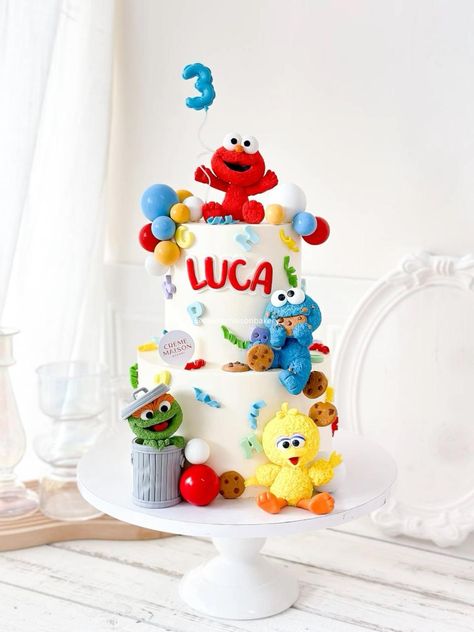 Bringing your child's favourites to life with our Sesame Street inspired cake! Featuring beloved characters like Elmo, Cookie Monster, Oscar, and Big Bird, each figure is handcrafted with attention to details for an extra special party. With colourful balloons, playful letters, and Cookie Monster’s signature treats, this cake is also a healthier option, low in sugar and crafted with rich flavours to delight party guests. Here’s to celebrating your child's big day with smiles, fun, and flavours that everyone will love!  For orders and enquiries, we can be contacted via whatsapp at +65 82817688! ✨  #bakerysg #sgcakes #customisedcakesg #birthdaycakesg #sesamestreet #sesamestreetcake Cookie Monster And Elmo Cake, Elmo Theme Party, Elmo Cake For Boys, Elmo 1st Birthday Party, Sesame Street Birthday Cake, Elmo Cakes, Dream Birthday Cake, Elmo 1st Birthday, 2nd Bday Cake