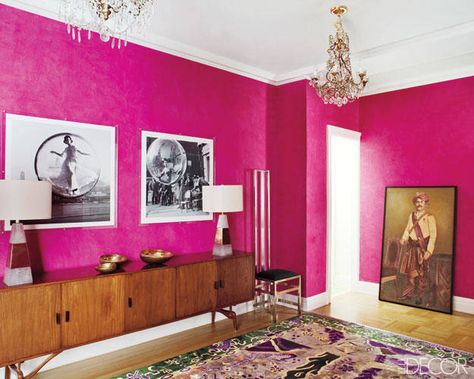 In the foyer, fashion photographs by Melvin Sokolsky are displayed above a 1960s Brazilian credenza. Hot Pink Walls, Warm Paint Colors, Murs Roses, Monochrome Makeup, Creative Wall Decor, Iphone Homescreen, Foyer Decorating, Shocking Pink, Clean Bedroom