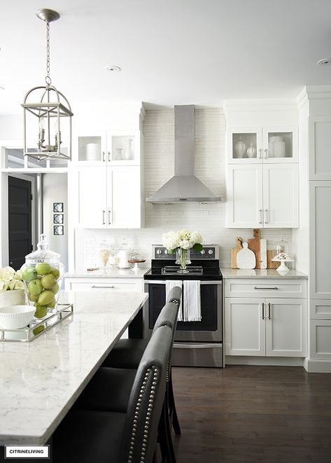 White kitchen with silver hardware, hardwood floors and grey island. White And Grey Kitchen, Modern Grey Kitchen, Grey Kitchen Designs, Gray And White Kitchen, Kitchen Island Decor, White Kitchen Decor, Kitchen Design Modern White, Classic Kitchen, White Kitchen Design