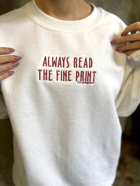 "\"Always read the fine print, I'm pregnant\" embroidered sweatshirt. Perfect cozy crewneck for a unique pregnancy announcement! Unisex sizing, size up for a true oversized look. Choose your sweatshirt color, and if you're looking for a different thread color message us to see if we have it :) 8 oz., 50% USA cotton, 50% polyester Pill-resistant air jet yarn Made with 50% sustainably and fairly grown USA cotton Read the fine print i'm pregnant sweatshirt, Read the fine print i'm pregnant embroidered sweatshirt, pregnancy announcement shirt, cute pregnancy announcement, i'm pregnant sweatshirt, pregnancy announcement, unique pregnancy announcement" Pregnant Announcement Shirt, Read The Fine Print Im Pregnant, Tell Him Youre Pregnant Ideas, Pregananant Announcement, Always Read The Fine Print Im Pregnant, We’re Pregnant Announcement To Family, Gifts For Pregnancy Announcement, Ways To Tell Your Sister Your Pregnant, Pregnant Reveal To Family