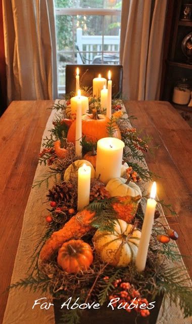 Evergreen sprigs and white candles of varying sizes are the backbone of this autumn tablescape. For an easy winter update,  remove the gourds and add pinecones, berries, and red fruit. Tafel Decor, Fall Deco, Autumn Decorating, Thanksgiving Centerpieces, Fabulous Fall, Deco Floral, Fall Centerpiece, Fall Table, Thanksgiving Decor