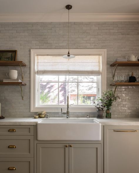 We love all the details that went into the English-inspired kitchen at our Modern Tudor project. The palette includes Farrow & Ball’s School House White, Wimborne White, and Dropcloth — which pair beautifully with the honed Calacatta Caldia marble, handcrafted zellige tile, and unlacquered brass. Zellige Tiles Kitchen, Zellige Tile Kitchen, White Oak Shelves, School House White, Taupe Kitchen, Modern Tudor, Wimborne White, Devol Kitchens, English Kitchens