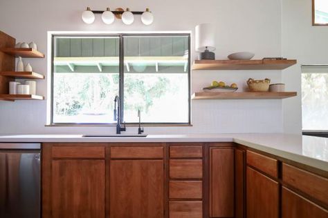 Kitchen designs circa 1950s and 1960s were all about light-colored walls, pastel design accents, flat paneled cabinets, and appliances with rounded corners and shiny metal handles. Of course, slipping entirely back into these midcentury designs is not necessarily the way to style your kitchen, but it might be fun to incorporate a few elements from a bygone era into your modern kitchen. One of the best places to start with a midcentury kitchen design is the wall color. Think pale yellow and green Restaining Kitchen Cabinets, Modern Kitchen Pictures, Distressed Kitchen Cabinets, Unfinished Kitchen Cabinets, Dark Wood Kitchen Cabinets, Antique Kitchen Cabinets, Recycled Kitchen, Top Kitchen Designs, Stained Kitchen Cabinets