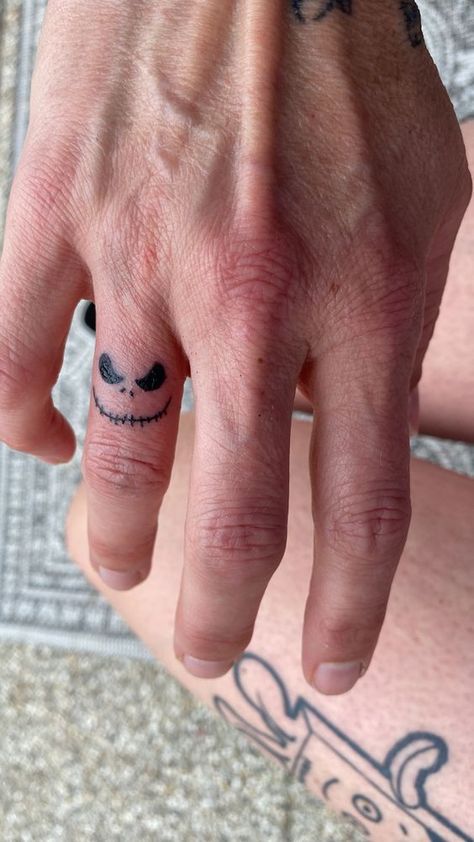 Jack Skellington tattoo finger Jack Skellington Finger Tattoo, Men's Small Tattoo Hand, Mens Tatoos Ideas Hand, Cute Small Tattoos For Men, Jack And Sally Finger Tattoo, Tatoos Men Hand Small Simple, One Hand Tattoo Men, Small Tattoo Ideas On Fingers, Men’s Finger Tats