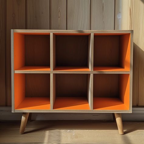 Create an image representing Nordic interior design. It features a wooden shelf with four legs and six square compartments, with the inner side of the compartments painted in orange. The shelf is left empty, emphasizing a minimalist and simple aesthetic --v 6 Square Bookshelf, Orange Shelves, Square Shelf, Nordic Interior Design, Bedroom Renovation, Simple Aesthetic, Wooden Shelf, Nordic Interior, Wooden Shelves