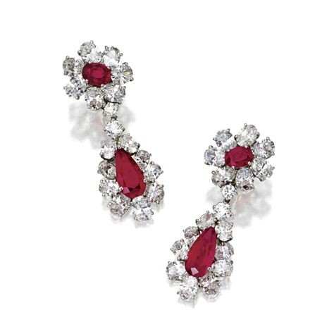 PAIR OF RUBY AND DIAMOND PENDANT-EARCLIPS, BULGARI The tops set with 2 oval rubies and the pendants with 2 pear-shaped rubies altogether weighing approximately 10.00 carats, framed by a total of 32 oval-shaped diamonds and connected by 4 round diamonds, all weighing a total of approximately 22.00 carats, mounted in platinum signed Bulgari.  With signed box. Ruby Diamond Earrings, Bulgari Jewelry, Titanic Jewelry, Bvlgari Jewelry, Diamond Pendent, International Jewelry, Ruby Earrings, Ruby Jewelry, Ruby Diamond