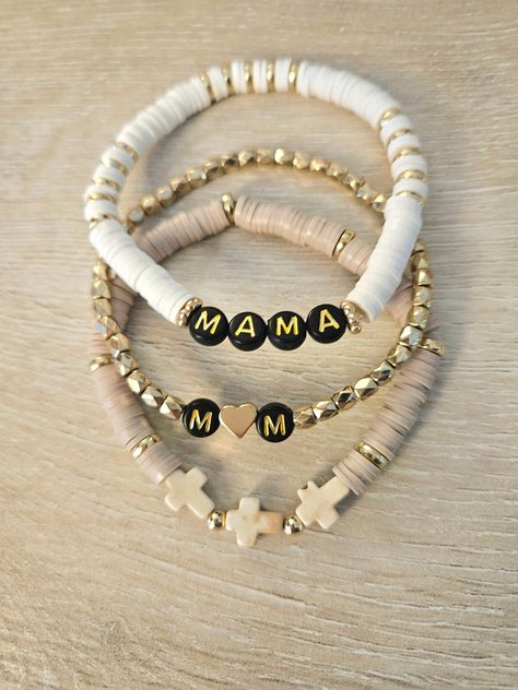 set of 3 white and gold beaded "mama" (or otherwise specified) bracelet with black letter beads, gold bracelet with initials (names) and heart, tan bracelet with semi precious magnesite crosses Diy Mama Bracelet, Boy Mom Bracelet, Gold Bracelets With Initials, Name Bracelet Ideas, Bracelets To Sell, Cute Gifts For Mom, Letter Bracelets, Heishi Bracelets, Cross Bracelets