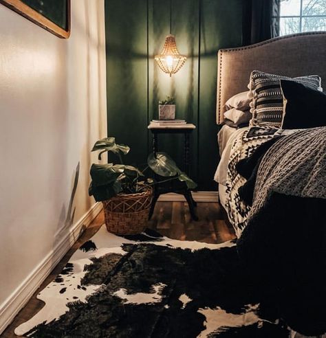 Moody Bedroom with Green Accent Wall and Cowhide Area Rug Moody Emerald Bedroom, Emerald Green Western Bedroom, Western Green Bedroom, Bedroom With Cowhide Rug, Cowhide Rug Bedroom Ideas, Hunters Bedroom, Western Rooms With Black Walls, Dark Green Western Bedroom, Green Western Bedroom