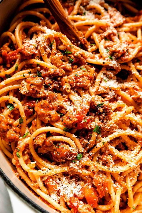 How to make restaurant-worthy Chicken Bolognese at home! A lighter take on the authentic Italian dish, made by simmering ground chicken with aromatic vegetables, wine, & tomatoes. The result is a healthy & hearty homemade sauce ready in 60 minutes or less! Toss the chicken bolognese sauce into a pile of bucatini or whatever pasta you love for the ultimate dinner! Make-Ahead & Freezer-Friendly, Slow Cooker directions provided! #chickenbolognese #chickenbolognesesauce #italianrecipes #pastarecipes Chicken Bolognese Sauce, Chicken Bolognese, Seafood Pasta Dishes, Turkey Bolognese, Pasta Bolognese, Bolognese Recipe, Family Restaurant, Bolognese Sauce, Seafood Pasta