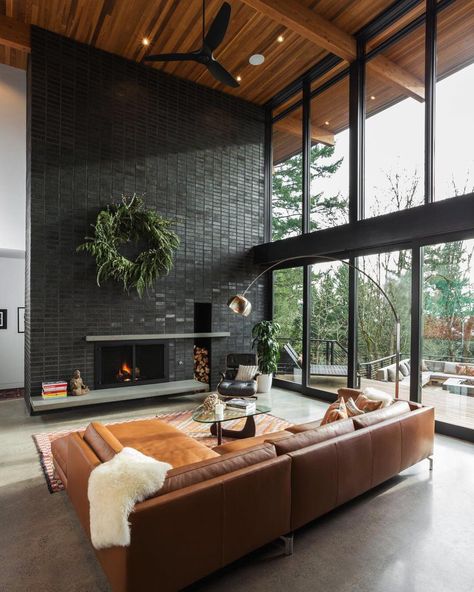 15 Black Brick Fireplace Ideas That Are Simply Stunning Black Brick Tile Fireplace, Black Brick Wall Living Room, Black Brick Fireplace Wall, Brick Tv Wall Ideas, Painted Brick Interior Wall, Limewash Brick Fireplace, Painted Brick Interior, Black Fireplace Wall, Grey Painted Brick