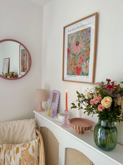 [Ad] Making Use Of Cute Accessories Is The Easiest Way To Upgrade Your Home. IM Obsessed With Colourful Home Interiors With A Vintage Twist, So When Decorating This Small Corner Of My Bedroom, I Focused On Florals, Pastel Colours And Interesting Shapes, Paired With Natural Materials Like Rattan Cane. Items Featured: Rattan Came Sideboard (Diy) Round Pink Mirror (Dunelm) Floral Wall Art (Ellie Mae Designs) Rattan Chair (Ikea) Boucle Throw #colourfullivingroomdecorsmallspaces Colourful Decor Aesthetic, Small Colourful Bedroom Ideas, Colourful Accessories Home, Simple Colourful Bedroom, Colourful Home Aesthetic, Floral Vintage Room, Small Colourful Bedroom, Bedroom Decor Pastel, Pops Of Colour Living Room