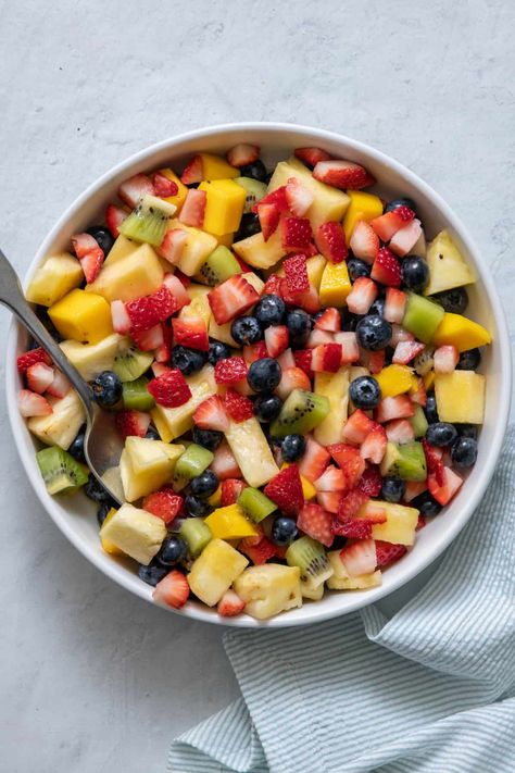 This Tropical Fruit Salad is easy to make and is packed with fresh kiwi, mangoes, pineapple, and berries. Plus, my "secret sauce" adds an interesting twist! | Fresh Fruit Salad | Tropical Fruit Salad Recipe | Fruit Salad Recipe | Kiwi Fruit Salad | Summer Salad | Tropical Fruit Salad Recipe, Christmas Fruit Salad, Stone Fruit Salad, Tropical Fruit Salad, Dressing For Fruit Salad, Yummy Fruit, Salad Summer, 2023 Recipes, Fruit Salad Easy