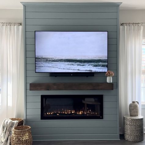 DIY Accent Wall Inspiration - For this new project, the “dynamic DIY duo” used build plans from fellow Touchstone collaborator @simply.diy.home as a starting point. “Seriously Stunning” -- This “dynamic DIY duo” chose the Sideline Elite® Electric Fireplace for this modern coastal shiplap accent wall. Erika shares, “This fireplace is seriously stunning - the flames and logs are so realistic.” Read More on the Blog: https://bit.ly/4aSxc3K Touchstone Sideline Elite® 50 Smart Electric Fireplac... Blue Shiplap Living Room, Coastal Living Rooms Accent Wall, Fireplace Wall Shiplap, Built Out Fireplace Wall Shiplap, Shiplap Behind Fireplace, Blue Tv Accent Wall, Modern Coastal Fireplace Wall, Electric Fireplace With Shiplap Wall, Blue Shiplap Fireplace Wall