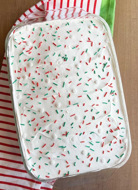 Christmas Jello Poke Cake is an easy dessert made with cake mix and red and green Jello. This easy recipe is perfect for the holiday Season! Christmas Poke Cake, Jello Poke Cake, Christmas Jello, Poke Cake Jello, Green Jello, Girls Lunch, Jello Cake, Holiday Sprinkles, White Cake Mixes