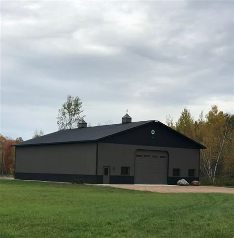 A 54' 0" x 72' 0" x 17' 2" Garage building with a Crinkle Finish - Matte Black roof, Crinkle Finish - Smokey Quartz siding and Crinkle Finish - Matte Black trim. For Mark in Ringle, WI (2019101216). Black Pole Barns, Black Metal Building, 40x60 Pole Barn, Cleary Buildings, Shed Foundation, Build Shed, Barn Colors, Metal Garage Buildings, Pole Barn Designs