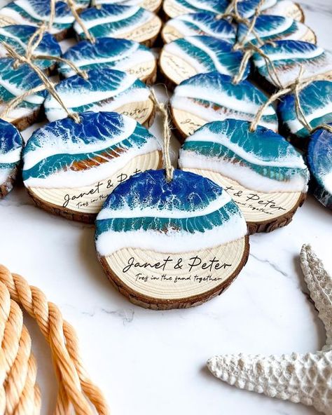 Amy & Kegan | Resin Art & Woodworking on Instagram: "☀️ TOP FIVE BEST SELLERS OF 2022 ☀️ This week I will take you through memory lane and show you our Top 5 Best Sellers of 2022 all in photos so you can see all their angles ♥️ Coming in at Number 2 - Our Personalized Ocean Ornaments! ☀️Yearly family Christmas ornament ☀️Keepsake of a favorite beach destination ☀️Memory of Baby’s first beach trip ☀️Wedding favors ☀️Engagement gifts ☀️Corporate gifts ☀️Girls trip ☀️Family trip souvenir ☀️ Resin Art Ornaments, Beach Souvenir Ideas, Oceanic Shell As Beach Season Gift, Resin Wedding Favors, Tenant Gifts, Beach Theme Resin Art, Family Ornaments Personalized Coastal, Ocean Ornaments, Resin Beach Ornaments