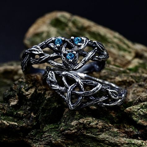 Crafted from sterling silver, our matching Viking wedding bands boast intricate designs inspired by celtic forests, perfect for couples seeking a unique symbol of their love. The wiccan love knot engagement ring adds a touch of mystique, while the aquamarine fantasy branch enhances its ethereal charm. This non-traditional set, featuring delicate branch and leaf motifs intertwined with celtic trinity knots. Characteristics: Metal - Recycled solid sterling silver  Stone - Cubic Zirconia Finish - Oxidized. View all silver celtic engagement rings: https://www.etsy.com/shop/TinyShinyJewel?ref=seller-platform-mcnav&section_id=44336419 Care instructions: To care for the ring, avoid contact with water and chemicals such as perfumes and lotions. When the ring is not in use, store it in a dry, cool Fantasy Wedding Rings Couple, Viking Wedding Ring Sets, Viking Engagement Ring, Celtic Forest, Fantasy Wedding Rings, Celtic Wedding Ring Sets, Knot Engagement Ring, Forest Ring, Viking Wedding Ring