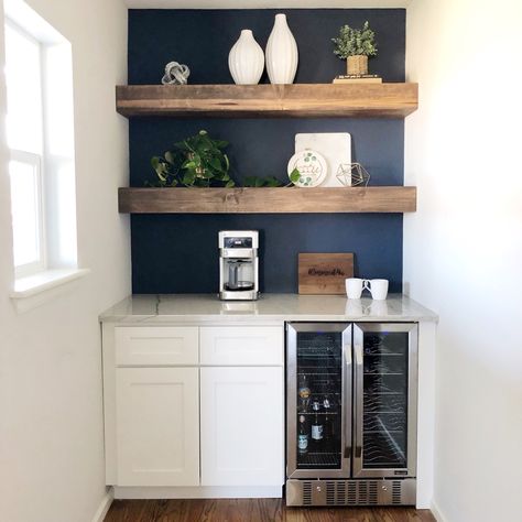 Modern coffee bar, floating shelves, wine bar, navy wall Gym Basement Ideas, Wall Indent, Navy White Kitchen, Mini Bar Home, Bar With Floating Shelves, Bar In Home, Kitchen Beverage Center, Kitchen Floating Shelf, Wine Cupboard