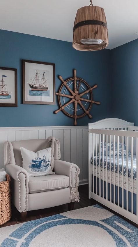 Nautical-themed gender-neutral nursery with blue walls, white wainscoting, crib, armchair, and ship decor, exuding Cute Nursery Ideas Boy, Nursery Ideas Navy Blue, Wainscoting Nursery Boy, Coastal Theme Nursery, Neutral Ocean Nursery, Ocean Nursery Baby Boy, Nautical Nursery Ideas, Sailing Nursery, Blue Baby Boy Nursery