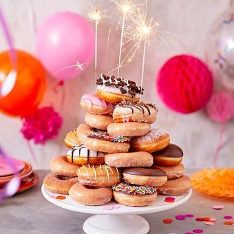 Donuts On Cake Stand, Donut Stacked Cake, Donut Birthday Stack, Doughnut Stack Cake, Donuts Stacked Like A Cake, Donut Birthday Tower, Tiered Donut Display, How To Make A Donut Cake Tower, Stacked Donut Cake Birthday