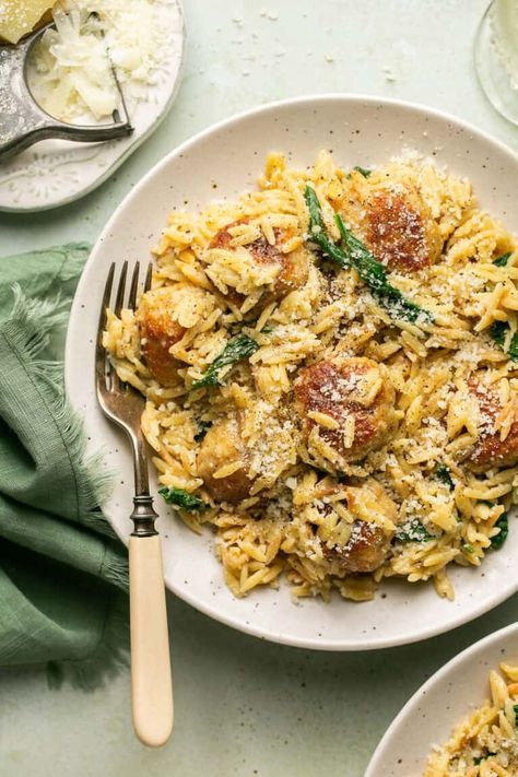 Enjoy the cheesy flavors of the classic Italian dish with this delicious Cacio e Pepe Chicken Meatball Skillet recipe. Made with lots of pecorino romano, this cheesy dish features chicken meatballs served atop a bed of creamy orzo. Meatball Skillet, Cheesy Orzo, Spinach Bread, Creamy Orzo, Chicken Meatball, Chicken Milk, Chicken Meatball Recipes, Pecorino Romano, Classic Italian Dishes