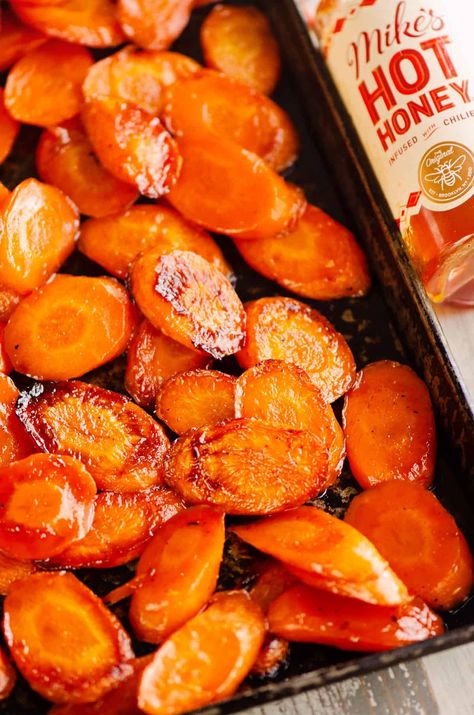 These Hot Honey Roasted Carrots are caramelized to perfection with a hint of spice from the chili infused honey. It's the perfect blend of sweet and spicy for a delicious side dish recipe. Hot Honey Vegetables, Honey Herb Carrots, Hot Honey Potatoes, Hot Honey Dishes, Sweet And Spicy Roasted Carrots, Spicy Thanksgiving Recipes, Hot Honey Glazed Carrots, Roasted Corn Side Dish, Honey Dill Carrots