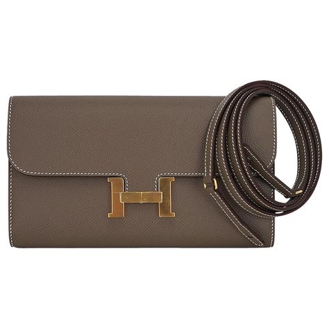 Mightychic offers an Hermes Constance Long To Go wallet featured in Etoupe with Gold hardware. Rich in Epsom leather. The consummate 'Wallet on a Chain'. Detachable strap allows you to carry the wallet/bag as a clutch. Classic Constance push lock with slot pocket under flap. Inside there are 2 slots for bills and 6 credit card slots. Central zip pocket with embossed pull. Front compartment is roomy enough for a phone. Rear slot pocket. HERMES PARIS MADE IN FRANCE is stamped on front under flap. Hermes Clutch Bag, Hermes Constance Wallet, Constance Hermes, Hermes Crossbody Bag, Hermes Constance Bag, Hermes Purse, Ysl Handbags, Christian Dior Handbags, Miu Miu Handbags