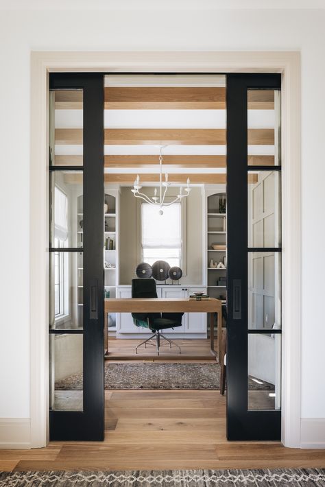 black entry doors to office with oak desk and shelves Double Glass Doors To Office, Pocket French Doors Interior Offices, Home Office Client Space, Glass Doors Home Office, Basement Office With French Doors, French Doors To Office Study, Double Door Office Entry, Barn Doors Office Space, Sliding Doors To Office