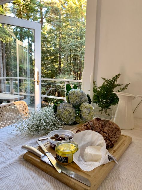 Table topped with white linen tablecloth, bread, cheese, and flowers French Countryside Party, French Country Backyard, French Lifestyle Aesthetic, French Countryside Aesthetic, French Countryside Home, French Country Aesthetic, Countryside Lifestyle, Girls Night Dinner, Gentle Living