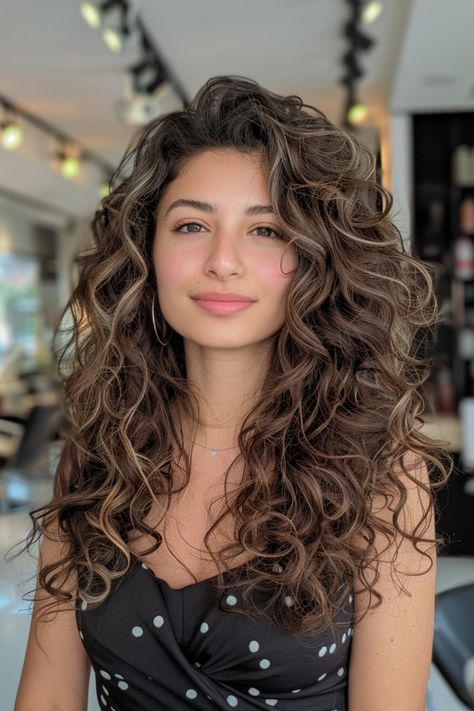 Woman with long, curly hair standing in a well-lit salon, wearing a black polka dot dress. Wavy Haircut Medium Length, Layers With Curly Hair, Wavy Haircut Ideas, Long Wavy Haircut, Haircut For Medium Length Hair, Wavy Haircuts Medium, Long Wavy Haircuts, Butterfly Layers, 2c Hair